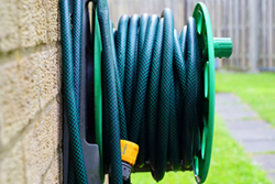 An outdoor garden hose reel