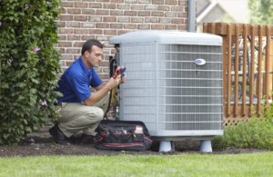 All Comfort Services technician performing a HVAC tune up outside