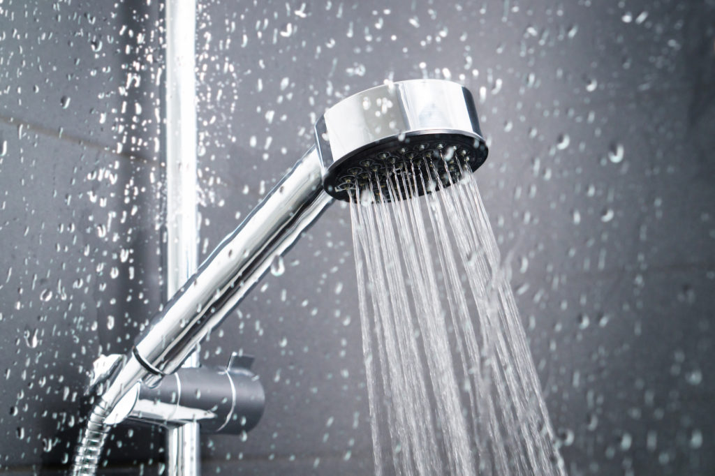 Energy- and water-saving showerhead with water flowing.