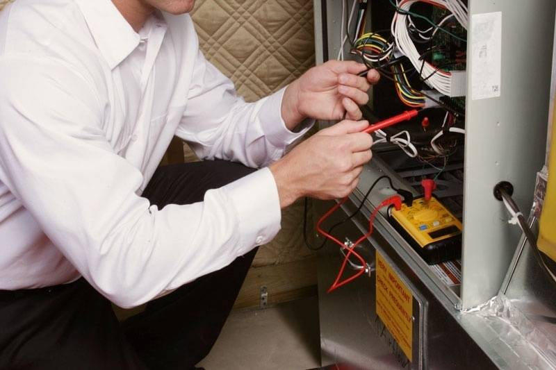 Technician repairing furnace