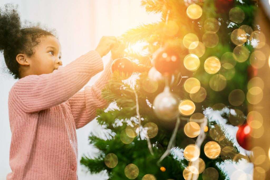 Girl decorating Christmas tree