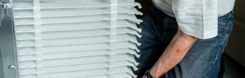 Homeowner inserting clean hvac filter