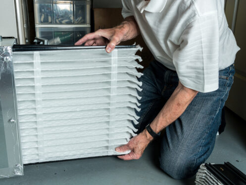 Homeowner inserting clean hvac filter